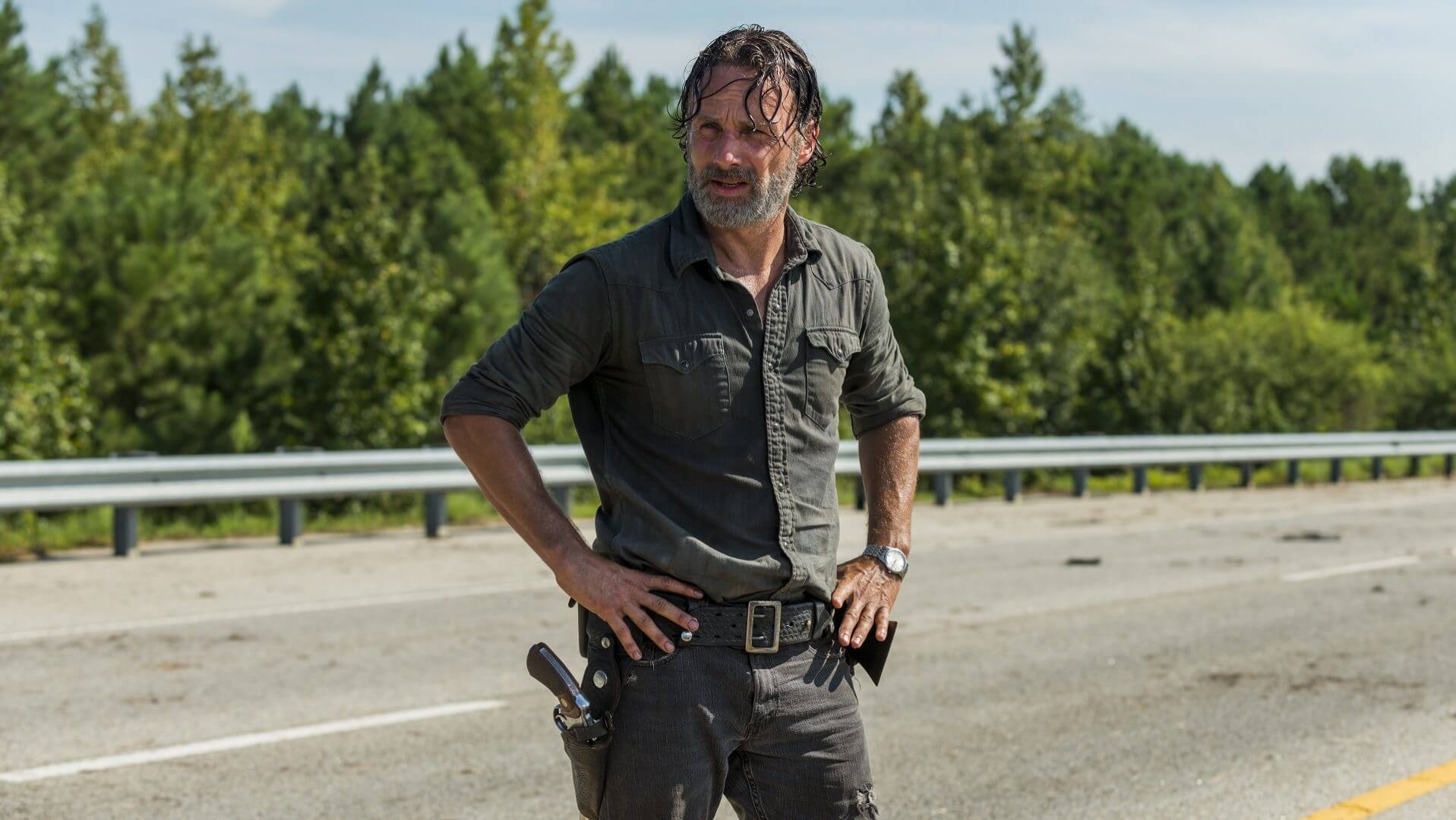 Rick Grimes standing on the road in the Walking Dead Rock in the Road