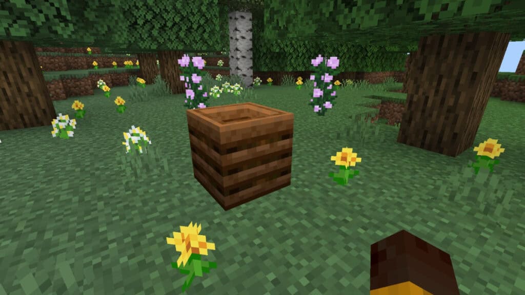 A Composter sitting among some flowers in Minecraft