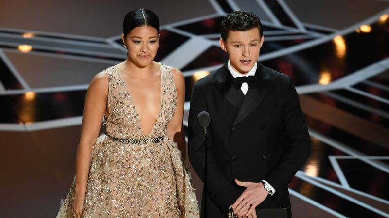 Tom Holland presenting at the 2018 Oscars with Gina Rodriguez- Holland is Rumored to Host Oscars 2022