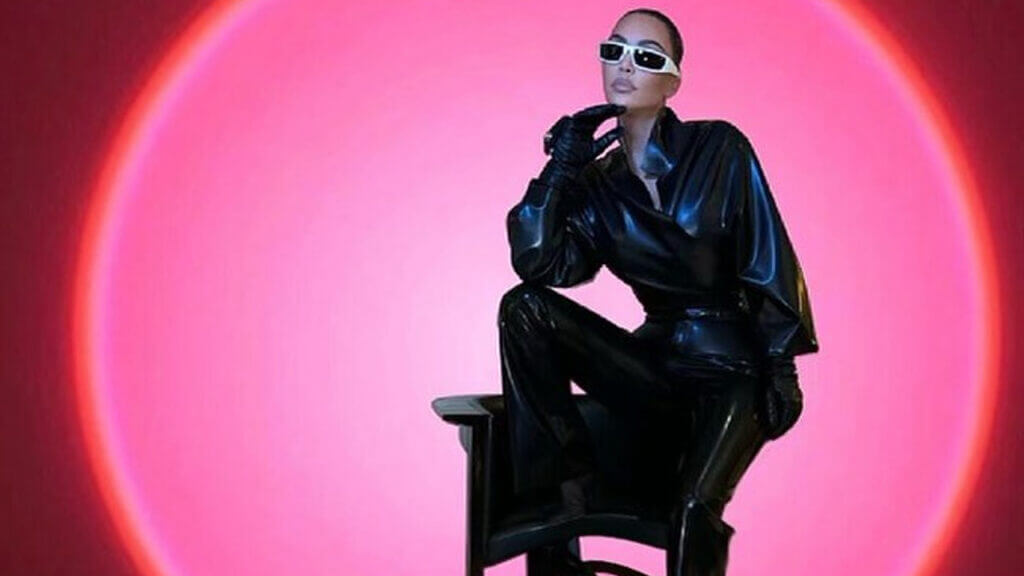 Ki kardashian poses in black leather outfit and white glasses