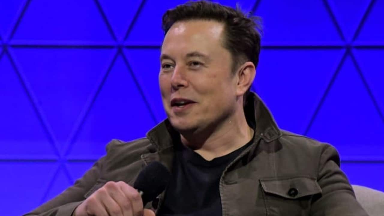 CEO of Twitter, Elon Musk speaks into a microphone