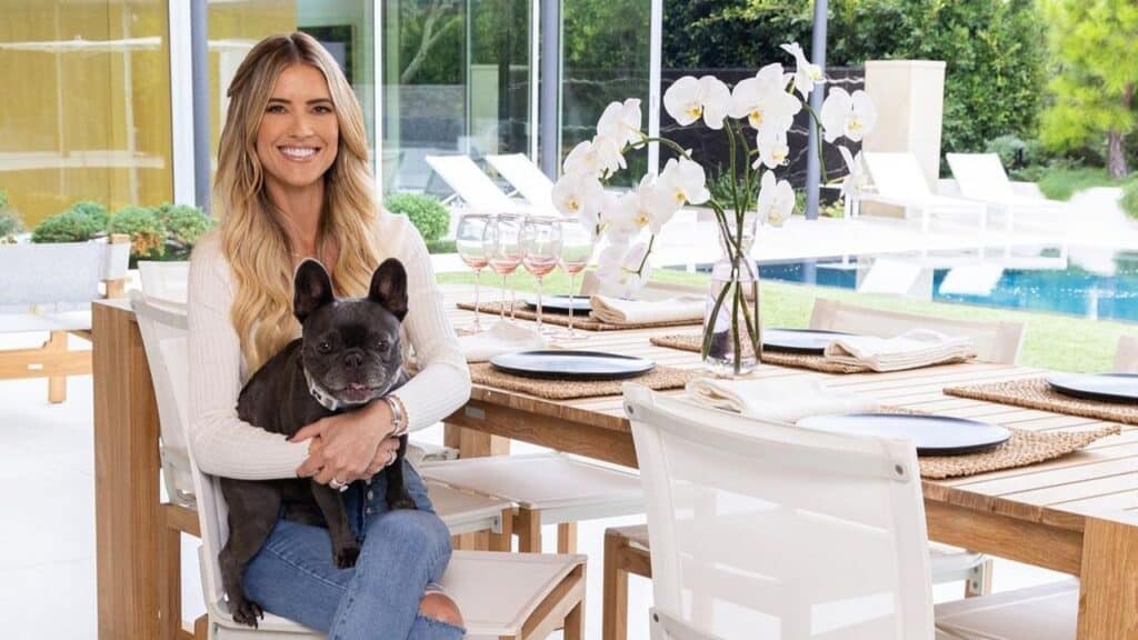 Christina Hall sits in her kitchen while holding her dog