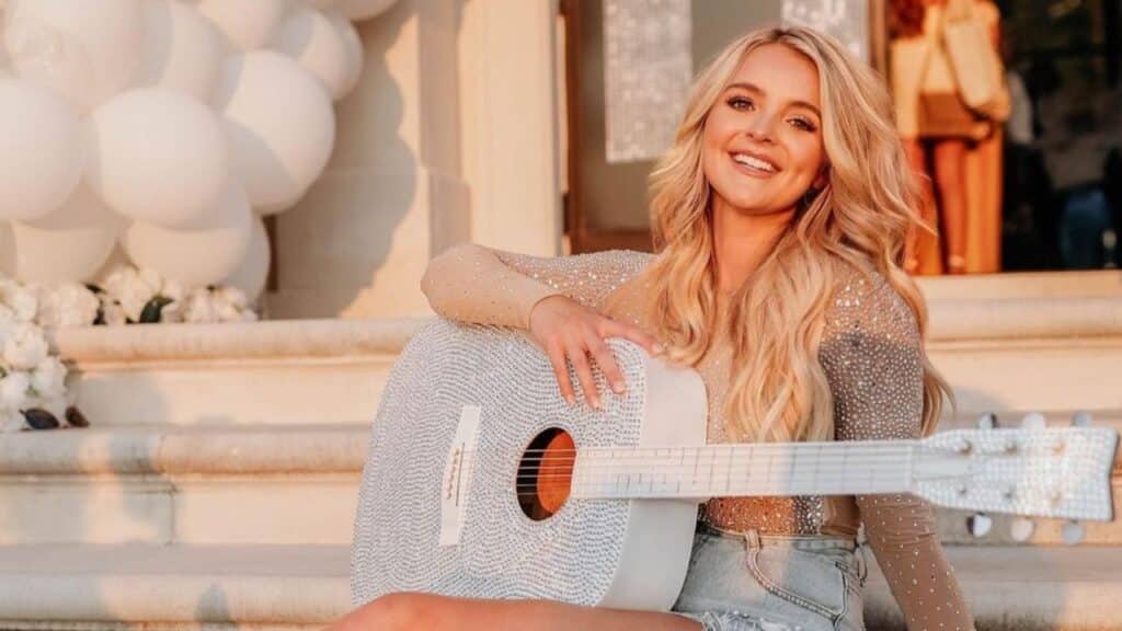 Charly Reynolds posing holding a guitar