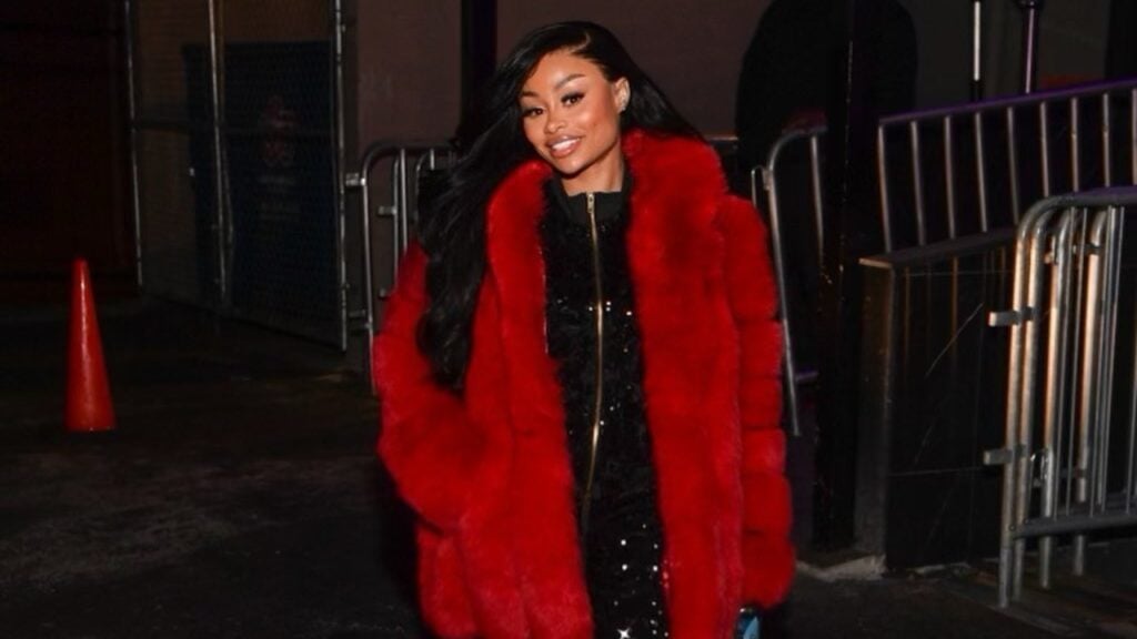 Blac Chyna rocks a red coat over blac outfit as she embace new look