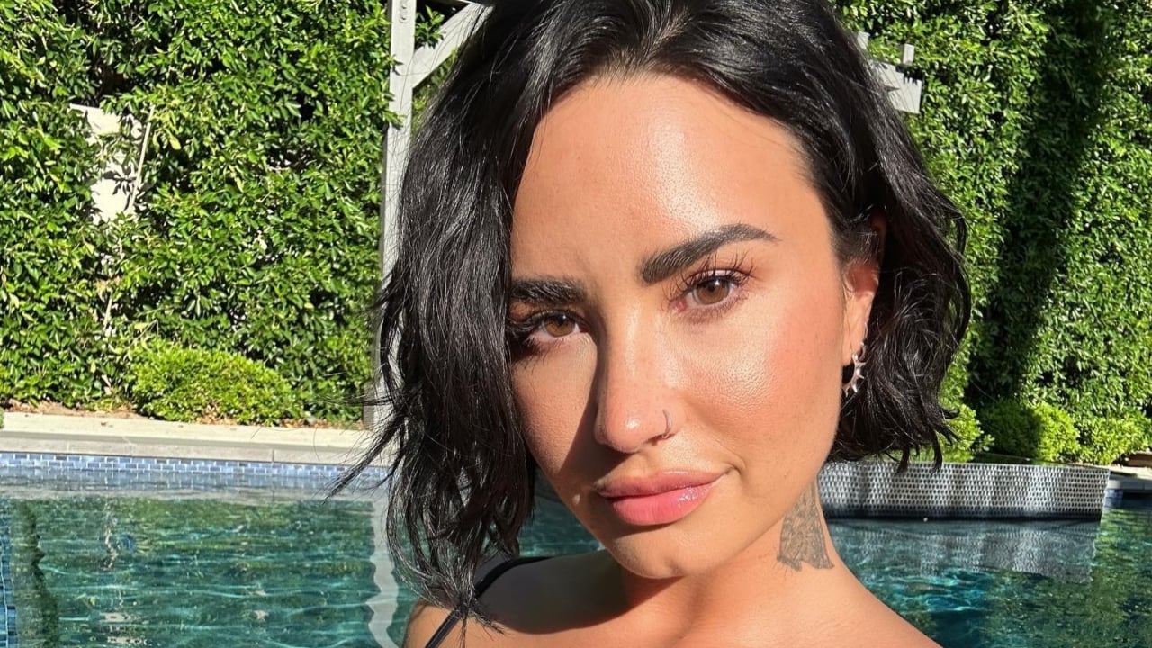 Demi shows off her killer curves in a plunging metallic