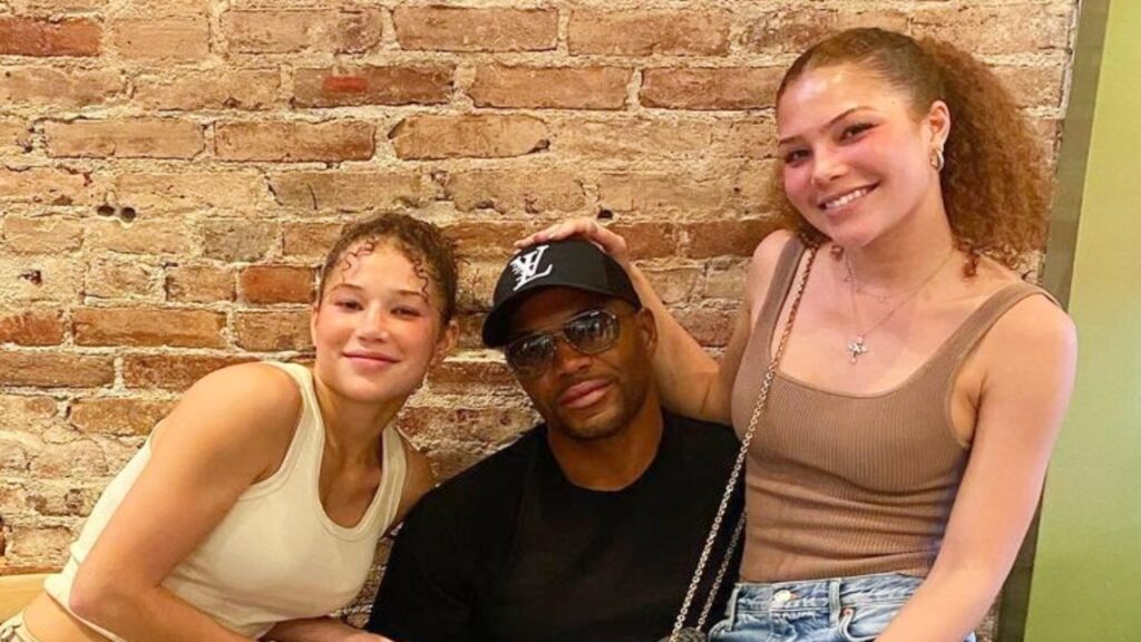 Michael Strahan poses with his twin daughters Sophia and Isabella