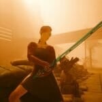 V poses with a katana in Cyberpunk 2077