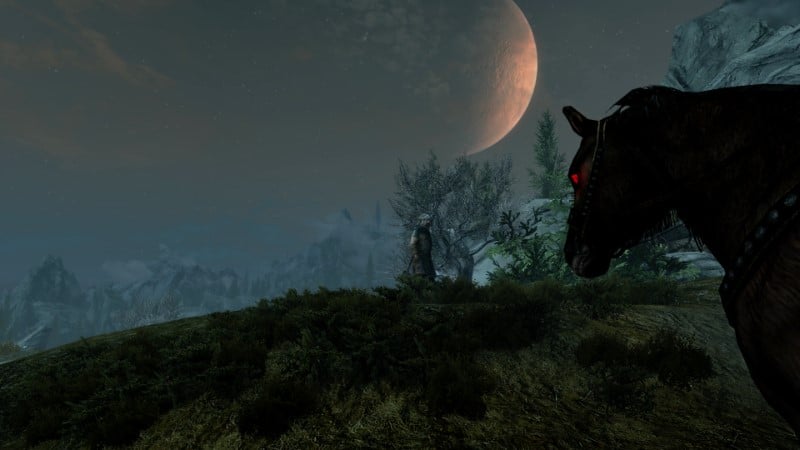 A horse looking at the moon in Skyrim, one of Bethesda's most immersive games