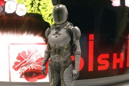 A bounty hunter poses in front of a sign in Starfield