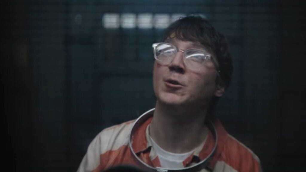 Paul Dano as the Riddler in The Batman sitting in a cell at Arkham Asylum