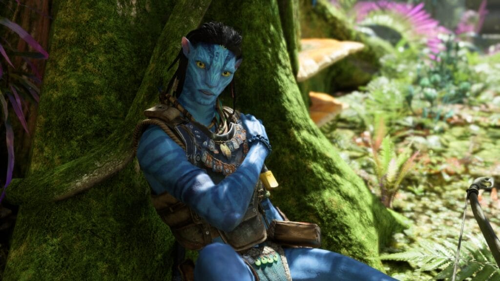 An injured Na'vi lies against a tree in Massive Entertainment's action-adventure game