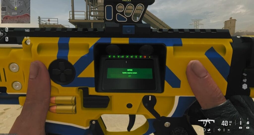 There is a shot of a gun with a small screen on it that reads update requires restart.