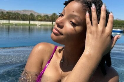 Pregnant Halle Bailey in a pool.