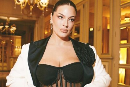 Ashley Graham poses in jumpsuit and jacket