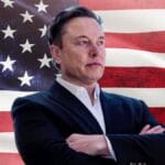 Elon Musk in front of an American flag