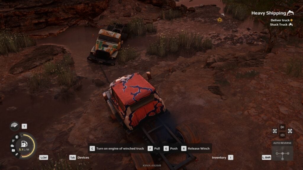 The player uses a winch to tow a truck stuck in the mud