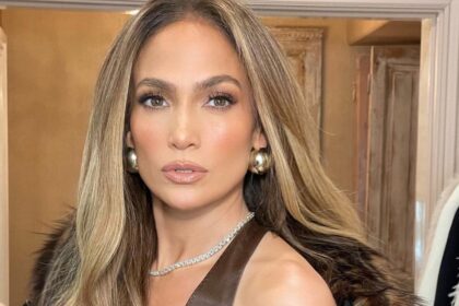 Jennifer Lopez in a brown fur coat and tank top.