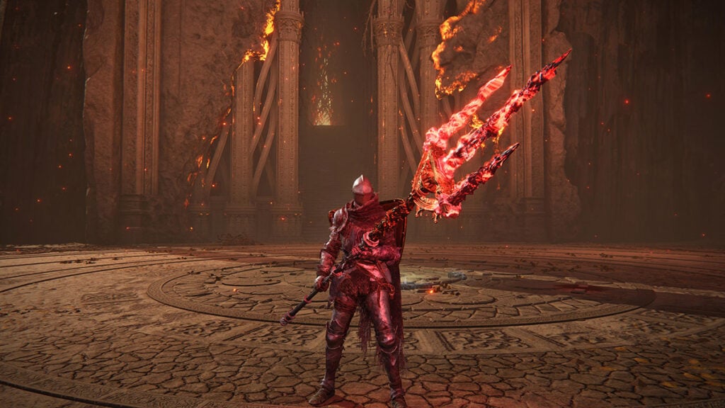 The Tarnished wields the bloodflame-infused Mohgwyn's Sacred Spear, one of the best Arcane weapons in Elden Ring.