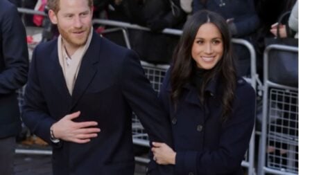 Prince Harry and Meghan Markle holding hands during a public appearance.