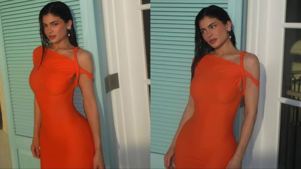Kylie Jenner wears a figure-hugging orange dress