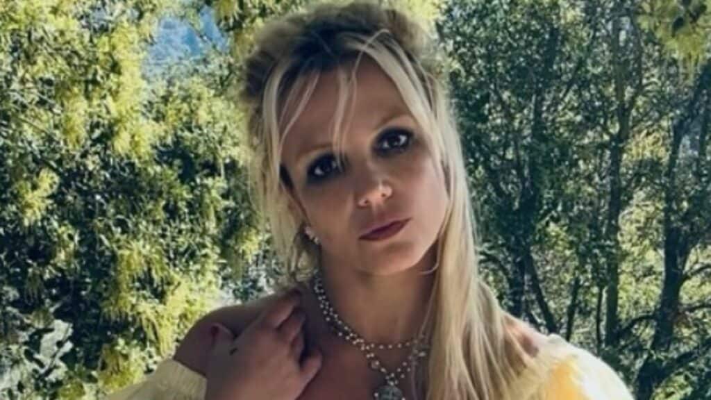 Britney Spears poses for picture in yellow outfit.