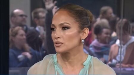 Jennifer Lopez in a blue dress gives an interview on her music, career, and marriage.