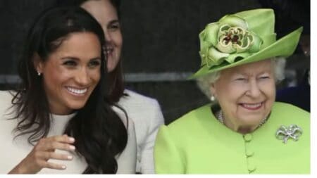 Meghan Markle and Queen Elizabeth smile during a royal engagement.