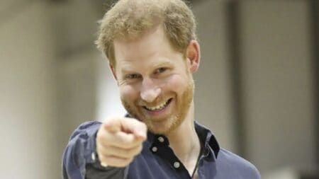 Prince Harry points to the camera
