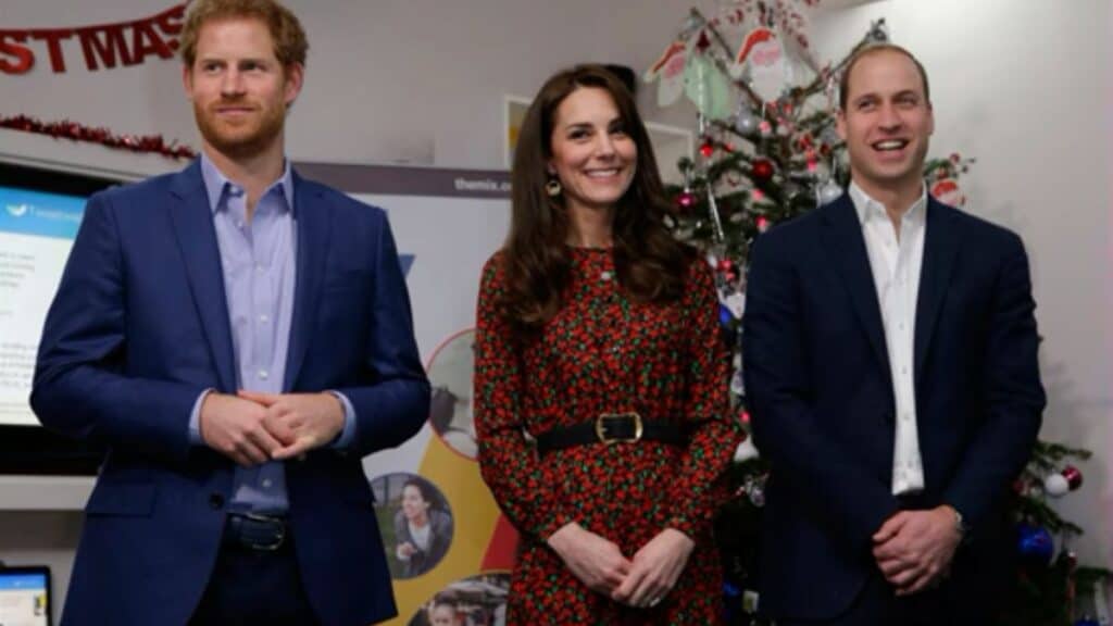 Prince Harry, Kate Middleton, and Prince William posing together during a public appearance.