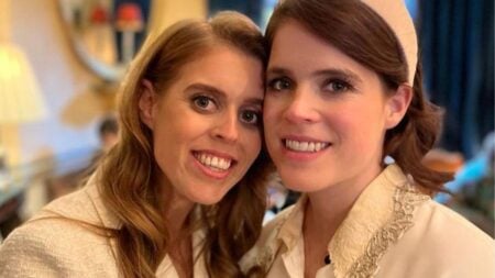 Princesses Beatrice and Eugenie smiling for a photo.