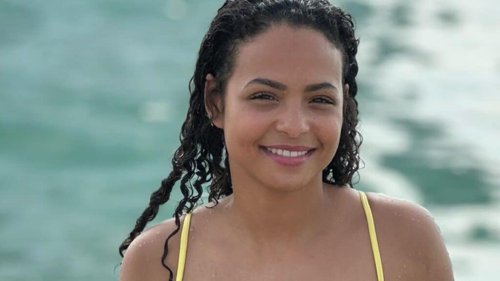 Christina Milian goes swimming in yellow swimsuit