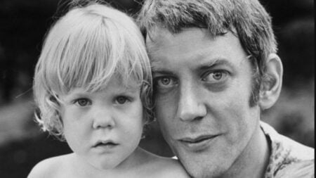 A black-and-white closeup of Donald Sutherland and his son