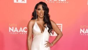 Kenya Moore on the red carpet in a white silk dress
