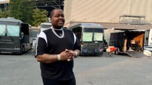 Sean Kingston standing outdoors in a black and white outfit