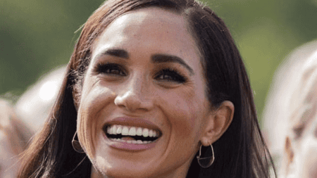 Meghan Markle Grinning with a Look of Pain