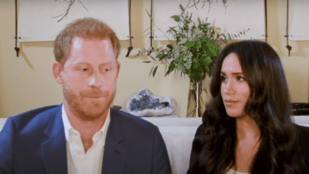 Prince Harry and Meghan Markle with Concerned Look Sitting on a Sofa
